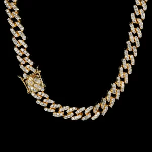 Upgrade your look with the Yellow Gold Iced Prong Miami Cuban Link Chain - 9mm. This stunning piece features a thick, high-quality Yellow Gold plating, ensuring a lasting, luxurious shine that never fades. The VVS Simulated Diamonds have been expertly cut to offer a high refractive index, delivering that signature bling bling look. Whether you're going for a formal vibe or adding some flair to a casual outfit, this chain brings a touch of elegance and style. It's the perfect choice for any Hip Hop fan who values both durability and affordability. Fade-proof, scratch-resistant, and waterproof, it's designed to withstand the test of time.