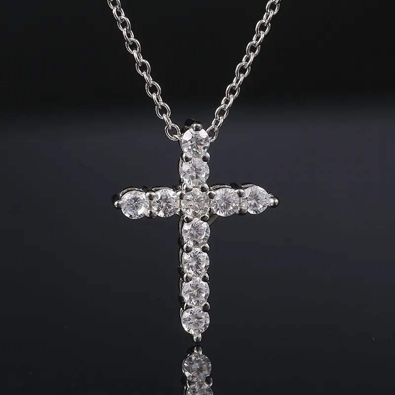 The White Gold 925SS Moissanite Cross Tennis Pendant combines the classic cross with tennis jewelry style. Featuring white gold and Moissanite stones, this hypoallergenic and waterproof pendant is ideal for adding a luxurious Hip Hop touch to any outfit.