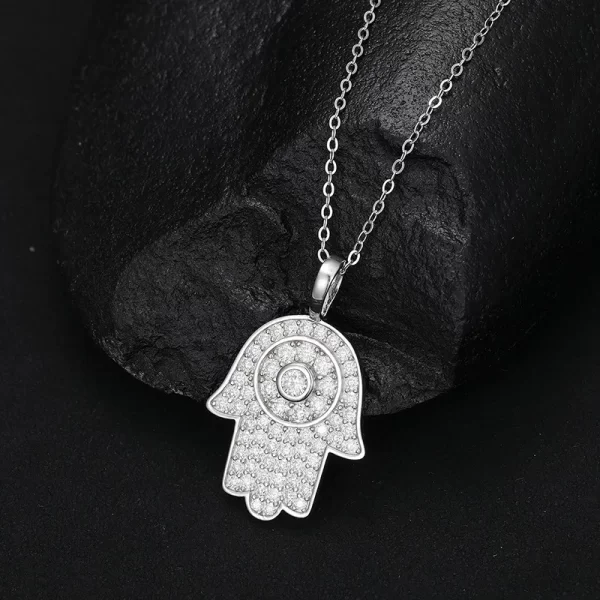 The White Gold 925SS Moissanite Hamsah Hand Pendant combines modern Hip Hop style with ancient symbolism. With its white gold and Moissanite detailing, this hypoallergenic and waterproof pendant is perfect for those looking to add a spiritual yet trendy piece to their collection.