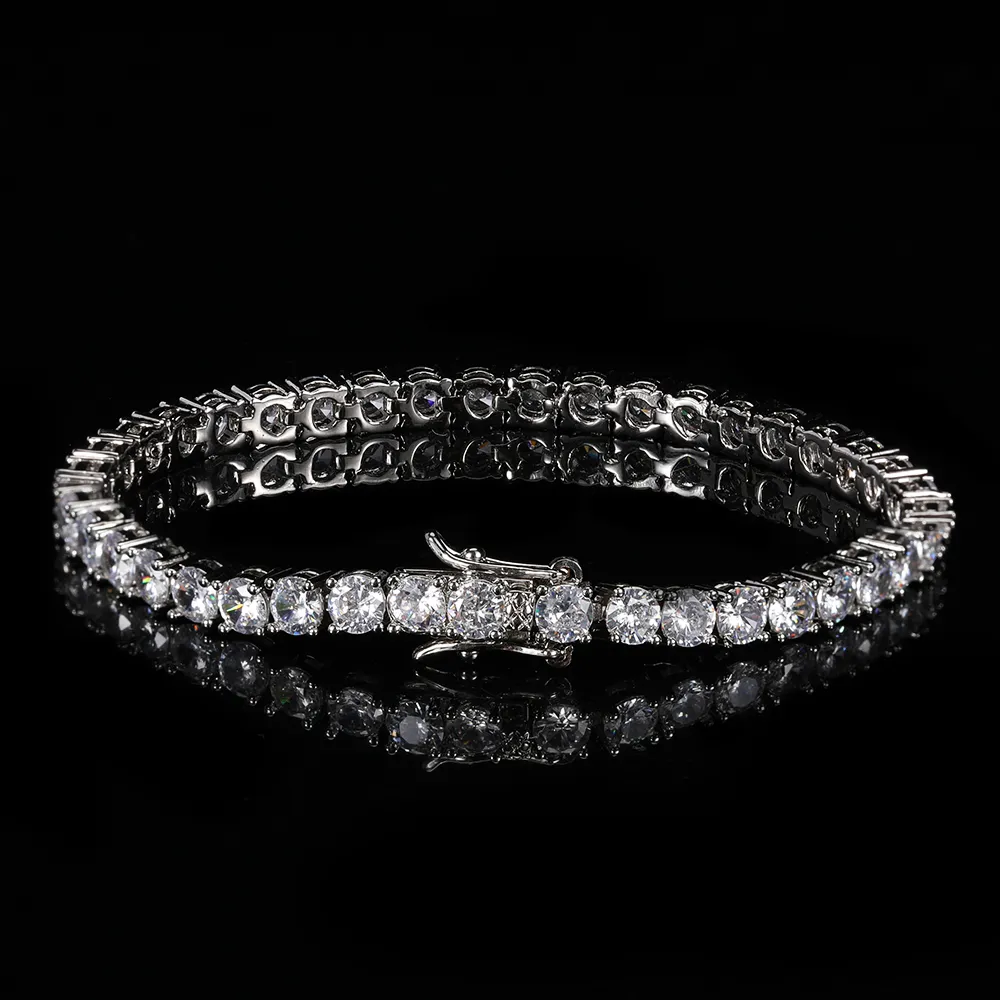 Make a statement with the Iced Prong Tennis Bracelet in White Gold - 5mm. Featuring VVS Simulated Diamonds prong-set along the entire bracelet, this 5mm piece adds undeniable brilliance to any outfit. The White Gold Plating offers both durability and a sleek, luxurious feel, making it ideal for both casual wear and special occasions.