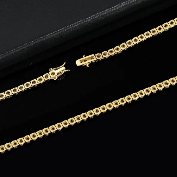 Add a touch of elegance with the Yellow Gold Iced Blingbling Tennis Chain - 4mm. This chain showcases a luxurious thick Yellow Gold plating that shines brilliantly, paired with rows of VVS Simulated Diamonds set in a secure prong design. Perfect for layering or wearing solo, the 4mm chain is a sophisticated statement piece that complements any outfit, from casual to formal. With its durable and scratch-resistant finish, it offers both style and long-lasting quality, making it an essential addition to any Hip Hop jewelry collection.