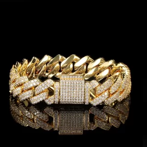 Add some serious bling to your wrist with the Iced Prong Miami Cuban Link Bracelet in Yellow Gold - 14mm. Featuring prong-set VVS Simulated Diamonds, this bold bracelet sparkles brilliantly while its Yellow Gold finish adds a luxurious touch. The wide 14mm design ensures durability and style, making it a perfect choice for both casual wear and formal occasions. The Yellow Gold Plating makes it ideal for anyone who loves standout jewelry.