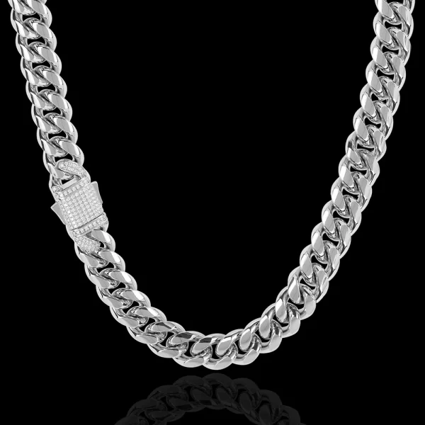 Enhance your wardrobe with the Iced Stainless Steel Cuban Link Chain in White Gold. This 10/12mm chain is designed to catch attention, featuring meticulously cut VVS Simulated Diamonds that sparkle in any light. Plated in a sleek White Gold finish, this chain offers a contemporary take on the classic Cuban Link design. Its durable stainless steel construction ensures lasting quality, making it perfect for anyone looking to add a touch of luxury to their everyday or formal attire.