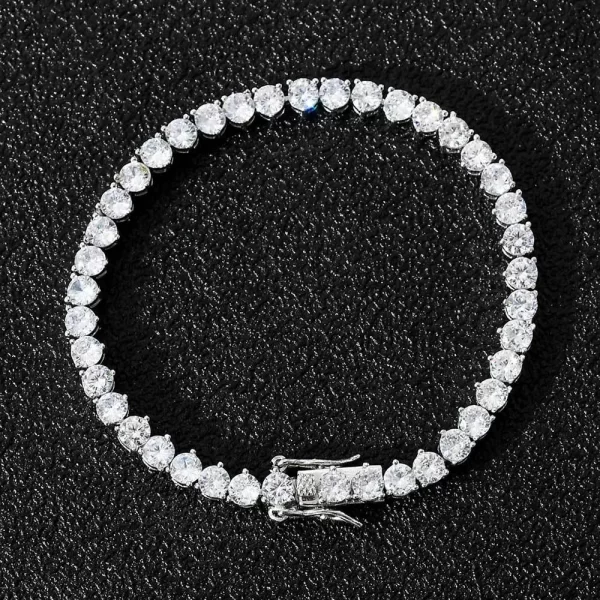 The Iced Prong Tennis Bracelet in White Gold - 4mm is a sleek and stylish accessory for Hip Hop fans who appreciate understated elegance. Prong-set with VVS Simulated Diamonds, this bracelet shines with subtle brilliance, while the White Gold finish ensures a modern, sophisticated look. Its 4mm width makes it perfect for everyday wear or special occasions, offering versatility and a refined touch to any outfit. Whether layered or worn solo, this bracelet adds a touch of luxury and style.