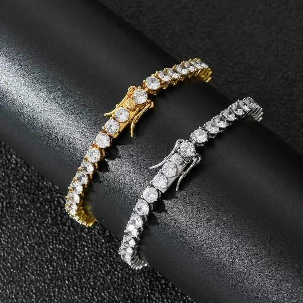 The Iced Prong Tennis Bracelet in Yellow Gold - 4mm delivers sleek elegance with a hint of luxury. This bracelet features prong-set VVS Simulated Diamonds along its 4mm width, giving off a refined shine. The Yellow Gold finish ensures both durability and style, making it perfect for both everyday wear and special occasions. Whether you're layering it with other bracelets or wearing it solo, this 4mm piece adds a subtle yet stylish bling to your wrist, perfect for Hip Hop lovers who want to add a touch of sophistication to their collection.