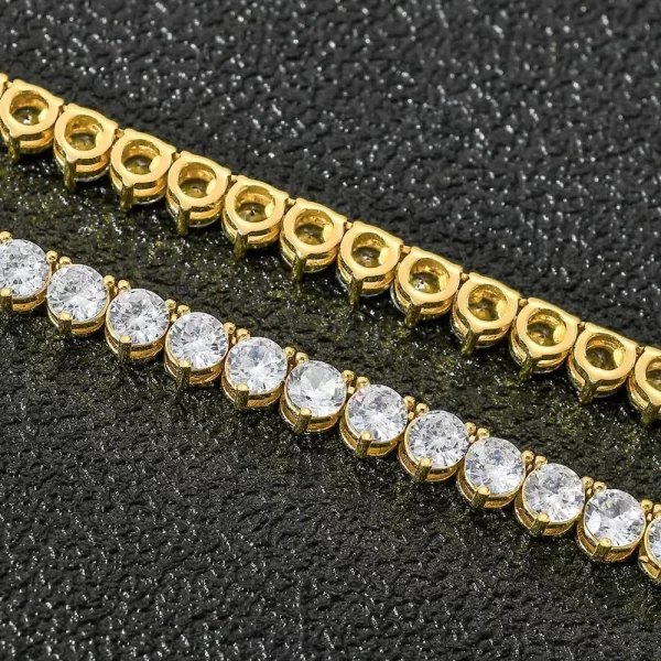 Add a sleek and modern touch to your style with the Iced Prong Tennis Chain in Yellow Gold. This 4mm Tennis Chain features prong-set VVS Simulated Diamonds that deliver maximum brilliance. Its slim 4mm width makes it perfect for layering or wearing solo. The Yellow Gold finish adds a luxurious touch, making it the ideal piece for any occasion. Whether you¡¯re going for a casual day out or dressing up for a formal event, this chain ensures you stand out with its dazzling shine and elegant design.