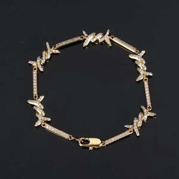 The Iced Thorns Bracelet in Yellow Gold - 3mm is designed for those who appreciate bold and edgy jewelry with a luxurious twist. Featuring thorn-like accents and prong-set VVS Simulated Diamonds, this bracelet delivers a subtle yet powerful statement. The Yellow Gold finish adds durability and an upscale touch, making it ideal for Hip Hop fans who want to elevate their everyday style. Whether worn alone or layered with other bracelets, this 3mm piece offers both versatility and standout appeal, perfect for adding a touch of bling to any outfit.