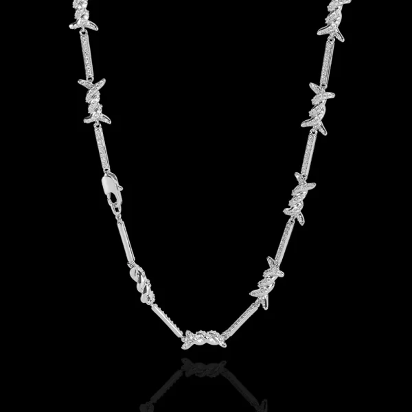 Make a statement with the Iced Thorns Chain in White Gold. This 3mm chain showcases sharp, thorn-like edges paired with a brilliant White Gold finish and VVS Simulated Diamonds. The sleek, minimalist design is perfect for those who want to add a touch of rebellion to their refined style. Whether you're dressing up or keeping it casual, this chain ensures your look stands out with a modern, edgy flair, making it ideal for anyone who loves bold, eye-catching jewelry.