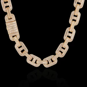 Make a bold statement with the Iced Square Mariner Link Chain in Yellow Gold. This 15mm chain combines a sturdy mariner design with dazzling VVS Simulated Diamonds, all finished with a luxurious Yellow Gold plating. The square mariner links add a modern touch, making it perfect for those who want a standout accessory for both casual and formal events. Its durable design ensures long-lasting wear, while the Yellow Gold finish brings elegance and shine to any look, making it a go-to piece for those who want to shine with confidence.