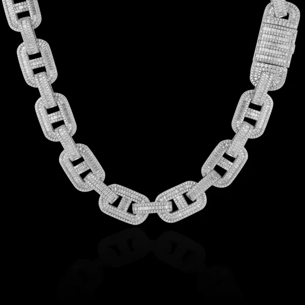 Upgrade your collection with the Iced Square Mariner Link Chain in White Gold. Featuring prong-set VVS Simulated Diamonds and a sleek 15mm mariner link design, this chain brings a modern twist to a classic style. The White Gold finish adds an elegant touch, making it perfect for those who want to elevate their look with a bit of luxury. Whether you¡¯re dressing up for an event or adding a touch of shine to your everyday style, this White Gold chain guarantees to stand out in any crowd.