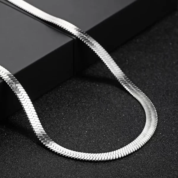 Elevate your style with the Herringbone Link Chain in White Gold. This 3-6mm chain offers a timeless, sleek design with a stunning White Gold finish. Made from durable stainless steel, the flat herringbone structure gives this chain a polished, luxurious look. Whether layered with other accessories or worn solo, its versatility makes it a perfect choice for both casual and formal settings. The White Gold adds an understated elegance, making this chain a must-have for any modern wardrobe.