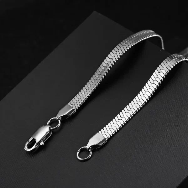 Elevate your style with the Herringbone Link Chain in White Gold. This 3-6mm chain offers a timeless, sleek design with a stunning White Gold finish. Made from durable stainless steel, the flat herringbone structure gives this chain a polished, luxurious look. Whether layered with other accessories or worn solo, its versatility makes it a perfect choice for both casual and formal settings. The White Gold adds an understated elegance, making this chain a must-have for any modern wardrobe.