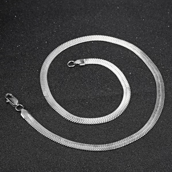 Elevate your style with the Herringbone Link Chain in White Gold. This 3-6mm chain offers a timeless, sleek design with a stunning White Gold finish. Made from durable stainless steel, the flat herringbone structure gives this chain a polished, luxurious look. Whether layered with other accessories or worn solo, its versatility makes it a perfect choice for both casual and formal settings. The White Gold adds an understated elegance, making this chain a must-have for any modern wardrobe.