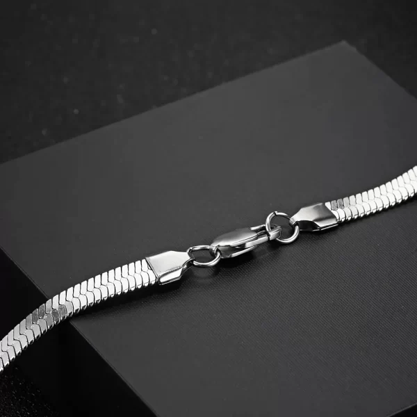 Elevate your style with the Herringbone Link Chain in White Gold. This 3-6mm chain offers a timeless, sleek design with a stunning White Gold finish. Made from durable stainless steel, the flat herringbone structure gives this chain a polished, luxurious look. Whether layered with other accessories or worn solo, its versatility makes it a perfect choice for both casual and formal settings. The White Gold adds an understated elegance, making this chain a must-have for any modern wardrobe.