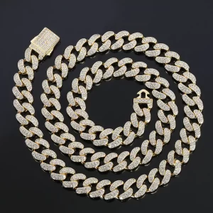 Make a bold statement with the Iced Prong Miami Cuban Link Chain in Yellow Gold - 12mm. This Cuban link chain is designed to deliver maximum shine with prong-set VVS Simulated Diamonds and a luxurious Gold Plated finish. Its 12mm width ensures a substantial presence, making it ideal for both casual and formal events. The warm, radiant Yellow Gold finish adds a touch of luxury, while the intricate prong setting ensures that the diamonds dazzle in any light, making this chain a must-have for those who want to elevate their Hip Hop style.