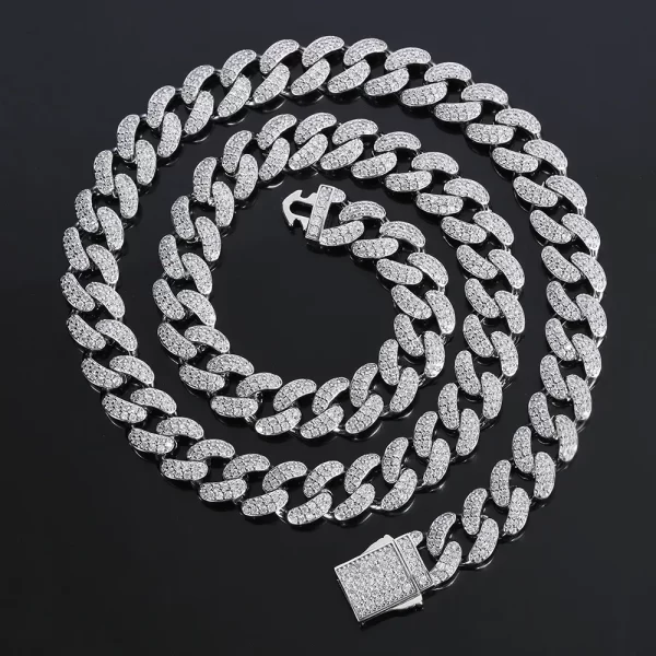 Upgrade your style with the Iced Prong Miami Cuban Link Chain in White Gold - 12mm. This chain features meticulously prong-set VVS Simulated Diamonds for a brilliant shine, while its White Gold finish offers a sleek and sophisticated look. The 12mm width gives it a bold presence, making it perfect for both casual and formal occasions. The modern, icy finish adds a refined touch, ensuring that this White Gold chain will be the centerpiece of any outfit, making you stand out in style.