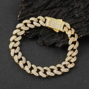 Shine bright with the Iced Prong Miami Cuban Link Bracelet in Yellow Gold - 12mm. This bracelet features prong-set VVS Simulated Diamonds, providing unmatched brilliance and style. The Yellow Gold finish adds a luxurious touch, making it ideal for Hip Hop enthusiasts who appreciate bold accessories. With its 12mm width, this bracelet offers both durability and a statement-making design that can elevate any outfit. Whether worn alone or layered, this piece is perfect for those who want to add some serious bling to their collection while maintaining a modern, luxurious aesthetic.