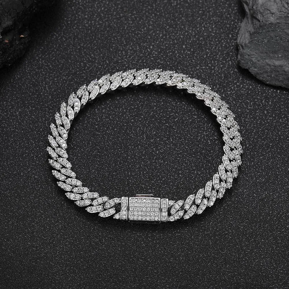 The Iced Prong Miami Cuban Link Bracelet in White Gold - 8mm offers the perfect combination of style and sophistication. Prong-set VVS Simulated Diamonds provide dazzling brilliance, while the White Gold finish adds a sleek, modern touch. This 8mm bracelet is designed for those who appreciate high-end fashion with a Hip Hop flair. Whether worn on its own or stacked with other pieces, this bracelet adds elegance to any look, making it ideal for both casual and formal occasions.