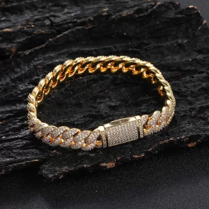 Stand out with the Iced Prong Miami Cuban Link Bracelet in Yellow Gold - 10mm. Featuring prong-set VVS Simulated Diamonds and a sleek Yellow Gold finish, this bracelet offers brilliance and durability. The 10mm design is both bold and stylish, making it the perfect accessory for those who want to make a statement with their wristwear.