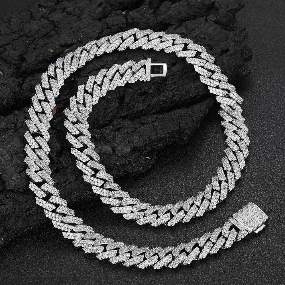 Add a touch of luxury to your collection with the Iced Diamond Miami Cuban Link Chain in White Gold. This 12mm Cuban link chain is adorned with prong-set VVS Simulated Diamonds, delivering maximum brilliance. The White Gold finish brings a sleek, modern look, making this chain a perfect accessory for both casual and formal events. Its 12mm width ensures it stands out whether you wear it solo or layered with other pieces. The Iced Out design guarantees that your style remains on point, offering both durability and shine.