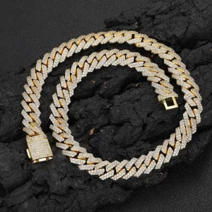 Shine with the Iced Diamond Miami Cuban Link Chain in Yellow Gold. This 12mm Cuban link chain is meticulously designed with prong-set VVS Simulated Diamonds, offering a perfect balance of luxury and style. The Yellow Gold finish adds a rich, polished look, making this chain ideal for both casual wear and special occasions. Whether worn alone or layered, its bold 12mm design guarantees to make a statement, delivering that classic Hip Hop bling. The high-quality craftsmanship ensures durability while the Yellow Gold plating provides a lasting shine.