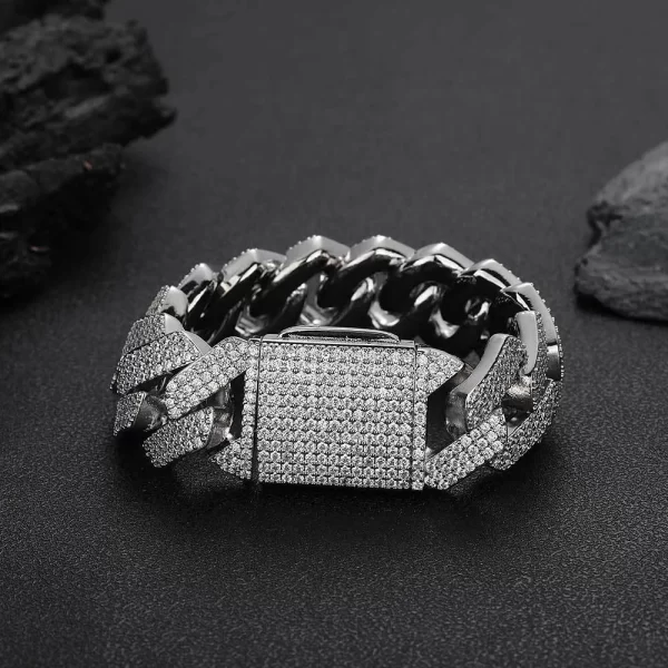 Make a bold statement with the Iced Diamond Miami Cuban Link Bracelet in White Gold - 25mm. Featuring prong-set VVS Simulated Diamonds for unmatched brilliance, this oversized bracelet with a White Gold finish adds a luxurious touch of Hip Hop style, perfect for those looking to stand out.