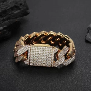 Make a bold statement with the Iced Diamond Miami Cuban Link Bracelet in Yellow Gold - 25mm. This oversized bracelet features prong-set VVS Simulated Diamonds for maximum shine, while its wide 25mm design ensures it stands out in any crowd. The Yellow Gold finish adds a luxurious touch, making it perfect for any Hip Hop enthusiast who loves bold, standout jewelry.