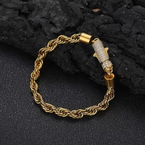 Keep it classy with the Iced Stainless Steel Rope Bracelet in Yellow Gold - 6mm. This 6mm bracelet is crafted from durable stainless steel and features a sleek, timeless rope design perfect for everyday wear or special occasions. The Yellow Gold finish adds a touch of luxury and blends effortlessly with your Hip Hop aesthetic.