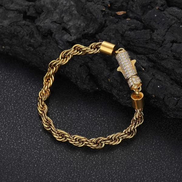 Keep it classy with the Iced Stainless Steel Rope Bracelet in Yellow Gold - 6mm. This 6mm bracelet is crafted from durable stainless steel and features a sleek, timeless rope design perfect for everyday wear or special occasions. The Yellow Gold finish adds a touch of luxury and blends effortlessly with your Hip Hop aesthetic.