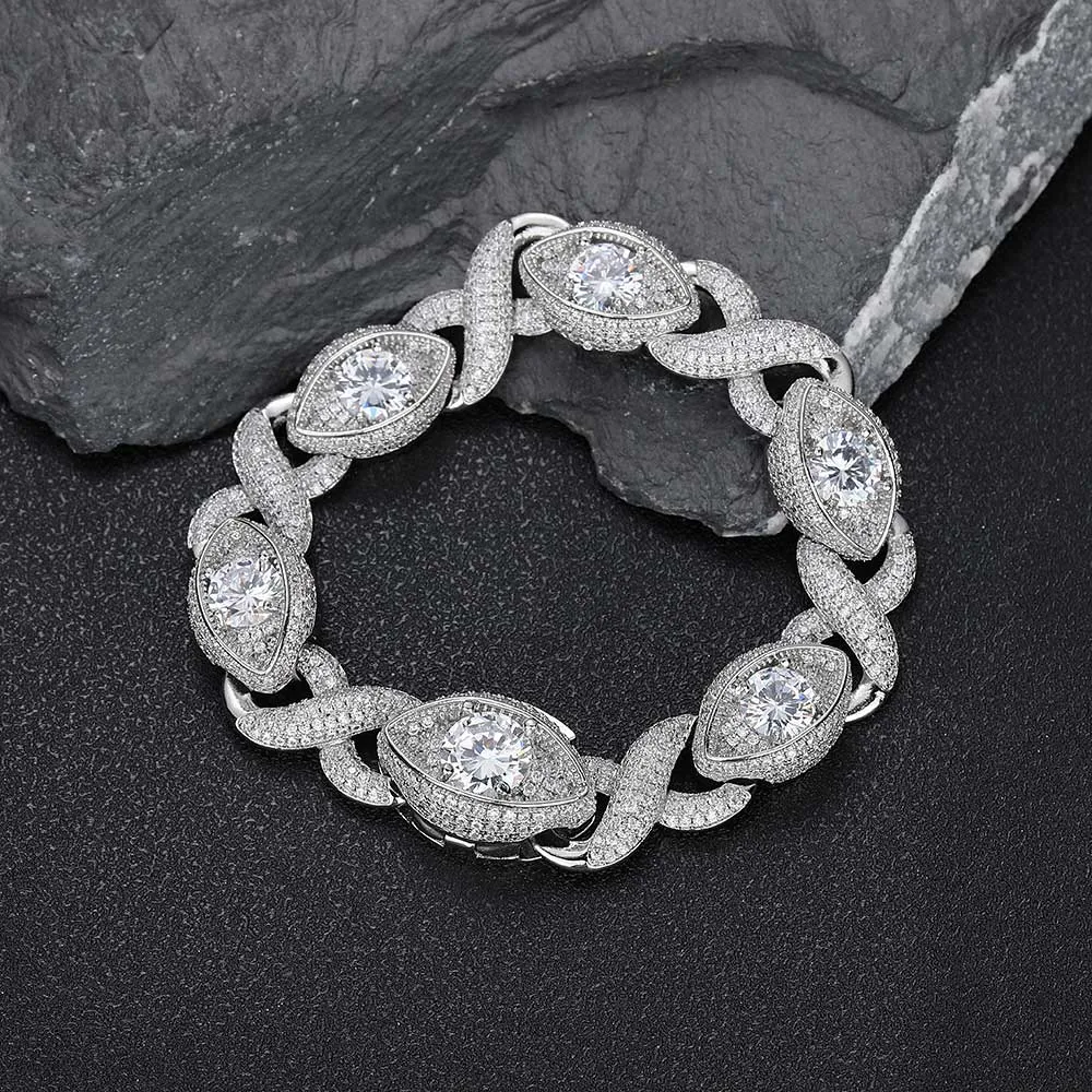 The Iced Infinite Eyes 8-Shaped Link Bracelet in White Gold - 15mm is a standout accessory for those who appreciate both elegance and edge. Prong-set with VVS Simulated Diamonds in a unique 8-shaped design, this bracelet offers a distinct shine and luxurious touch. The White Gold finish enhances its sophistication, making it perfect for both casual wear and formal events. Hip Hop enthusiasts will love how this 15mm bracelet blends modern style with timeless appeal, ensuring it remains a statement piece in any jewelry collection.