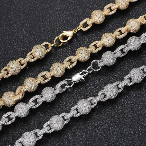 Add a unique touch to your style with the Iced Beaded Rolo Chain in Yellow Gold. This 11mm chain is crafted with an intricate beaded design and paired with VVS Simulated Diamonds for a luxurious and eye-catching look. The Yellow Gold finish adds a warm, rich shine, making it the perfect piece for layering or wearing solo. Whether you¡¯re dressing up for a special occasion or adding a touch of luxury to your daily wear, this chain ensures both durability and elegance.