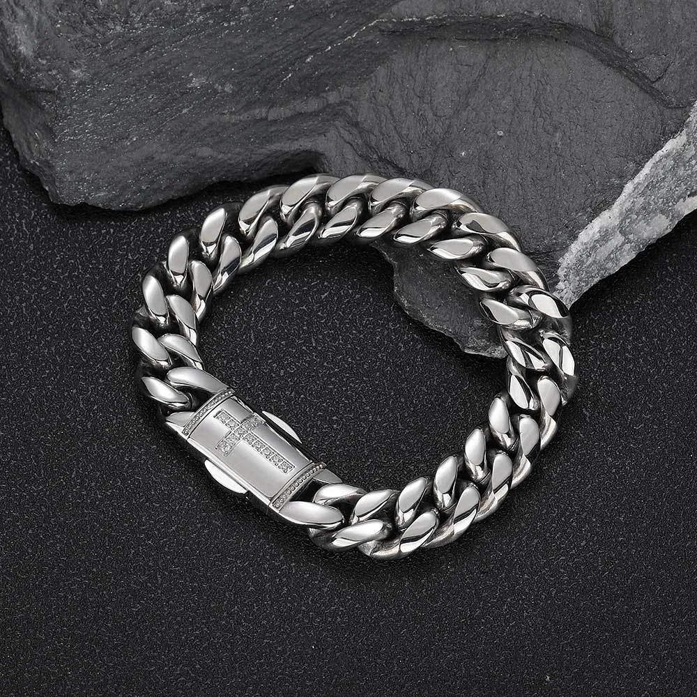 The Iced Cross Stainless Steel Miami Cuban Link Bracelet in White Gold - 12mm offers a sleek and refined take on Hip Hop fashion. Prong-set with VVS Simulated Diamonds, this 12mm bracelet shines in any light, while the White Gold finish ensures durability and style. Whether worn solo or layered, this piece is perfect for adding a touch of luxury to any outfit.