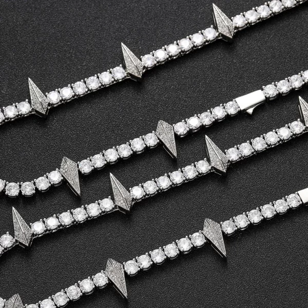 Step up your style with the Iced Wakanda Panther Tennis Chain in White Gold. This 6mm chain gleams in White Gold, delivering a sophisticated, modern look. The VVS Simulated Diamonds reflect a dazzling shine while the sleek White Gold finish ensures versatility for both formal events and everyday wear. Inspired by the Wakanda Panther design, this piece adds cultural significance to your collection, making it a must-have for those who want a standout accessory with a hint of luxury and tradition.