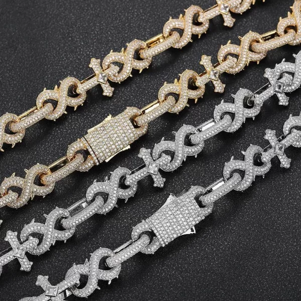 Make a bold statement with the Iced Cross Thorns 8-Shaped Link Chain in Yellow Gold. This unique 16mm chain combines cross and thorn details with VVS Simulated Diamonds for a bold and edgy look. The Yellow Gold finish ensures that this chain stands out whether you're at a party or dressing up for a special event. Perfect for those who want to showcase their individuality and add a touch of luxury to their outfit, this piece is designed for maximum impact while delivering a luxurious shine.