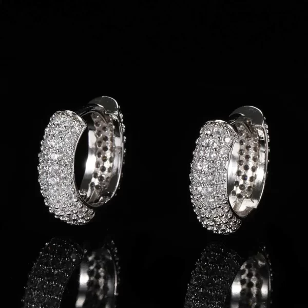 The Iced Hoop Earring in White Gold brings elegance and edge to your everyday look. Its 15mm size offers a balanced, bold look, while the diamond-simulated stones ensure a luxurious shine. Whether worn for a special occasion or as a standout piece in your daily outfit, these earrings add a touch of Hip Hop style with a sophisticated twist.