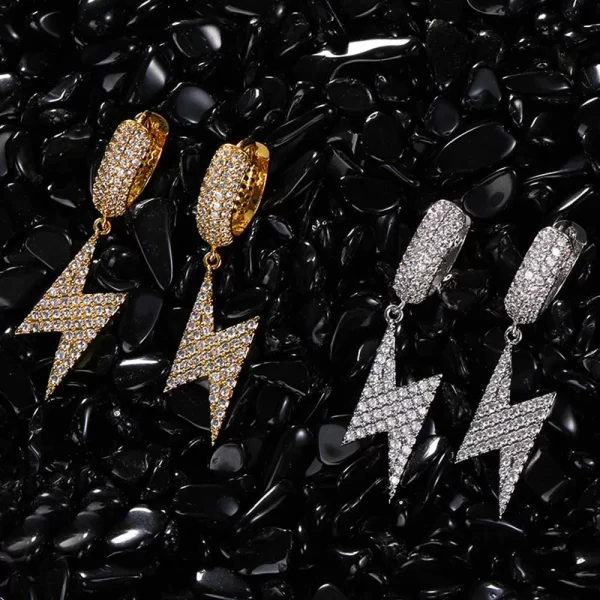 Strike like lightning with these Iced Lightning Hanging Earrings. The gold-plated finish and bold lightning design make a statement, while the sparkling simulated diamonds add a bright flash. Perfect for when you want to stand out and electrify your look, these earrings offer a unique blend of energy and style. Whether for a night out or an event, they add that perfect Hip Hop vibe to your collection.