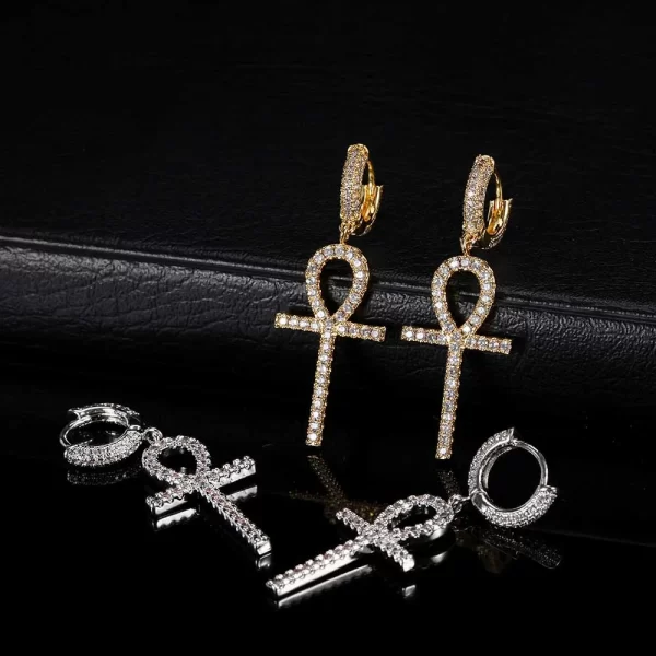 The Iced Ankh Cross Hanging Earrings in White Gold offer a modern twist on an ancient symbol. With a sleek White Gold-plated finish and shining simulated diamonds, these earrings are designed for those who love to mix fashion with meaning. Ideal for Hip Hop lovers looking to add both elegance and cultural symbolism to their jewelry collection.