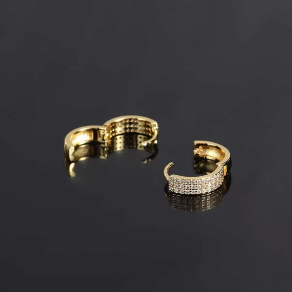 Upgrade your earring game with the 3 Layer Iced Hoop Earring - 14mm. At 14mm, these hoops feature three layers of simulated diamonds that offer maximum shine. The gold-plated finish adds durability, ensuring these hoops won¡¯t fade, and keeps you shining bright for any occasion. Whether you¡¯re dressing up for a special event or adding extra bling to your streetwear, these hoops offer a perfect balance of Hip Hop flair and luxury.