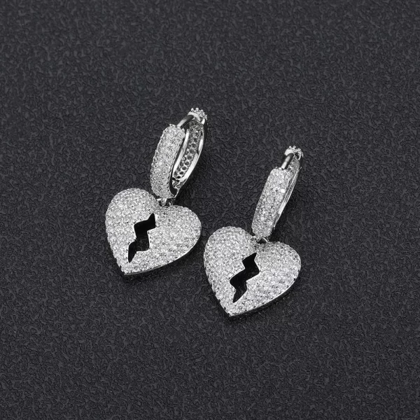 The Iced Heartbroken Stud Earring in White Gold offers a more refined take on the classic heartbroken design. Featuring diamond-simulated stones that sparkle with every movement, this piece is both elegant and bold. Its White Gold finish ensures a luxurious feel, perfect for adding a touch of sophistication to your Hip Hop-inspired look, whether for casual wear or a statement outfit.