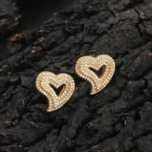 Express your love with the Iced Heart Stud Earring, featuring a delicate heart design adorned with diamond-simulated stones. The gold-plated finish ensures a lasting shine, while the sleek stud design keeps it comfortable for everyday wear or special occasions. This earring is perfect for those who want to add a bit of romantic flair to their Hip Hop style, making a bold yet elegant statement with every wear.