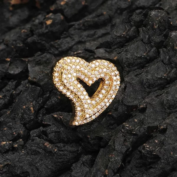 Express your love with the Iced Heart Stud Earring, featuring a delicate heart design adorned with diamond-simulated stones. The gold-plated finish ensures a lasting shine, while the sleek stud design keeps it comfortable for everyday wear or special occasions. This earring is perfect for those who want to add a bit of romantic flair to their Hip Hop style, making a bold yet elegant statement with every wear.