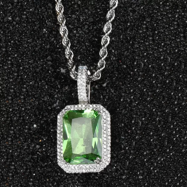 The White Gold Peridot Stone Pendant offers a fresh and modern look with its vibrant green gemstone set in a sleek White Gold-plated frame. Surrounded by VVS simulated diamonds, this pendant adds a pop of color to your Hip Hop style. Hypoallergenic and durable, it’s designed for long-lasting wear, making it perfect for both casual and formal occasions. The cool tones of the White Gold finish complement the peridot’s refreshing green hue, creating a standout accessory for any jewelry lover.