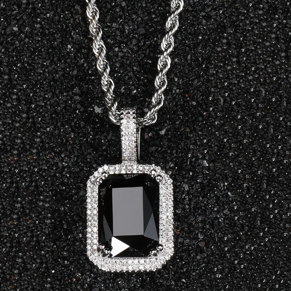 The White Gold Black Gemstone Pendant brings an edgy, modern flair to any outfit. Featuring a deep black gemstone encased in VVS simulated diamonds, the White Gold-plated frame offers a sleek contrast, perfect for those who appreciate bold elegance. Hypoallergenic and scratch-resistant, it’s built for long-lasting wear. The cool White Gold finish adds a sophisticated touch to the gemstone’s rich darkness, making this pendant a versatile piece for any Hip Hop-inspired wardrobe.