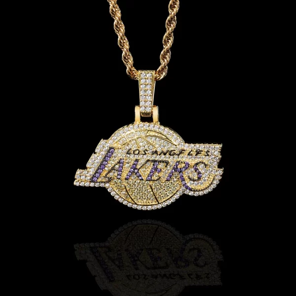 Show off your team pride with the Iced Lakers Pendant in Yellow Gold, perfect for any basketball fan. This pendant features a bold, gold-plated Lakers logo encrusted with dazzling stones that bring a luxurious, iced-out finish. Hypoallergenic, waterproof, and scratch-resistant, it’s designed for everyday wear whether you’re courtside or out on the town. The combination of team spirit and bling makes this pendant a standout piece for any Lakers supporter. Wear it with pride and let everyone know who your favorite team is, adding a touch of Hip-Hop flair to your collection.