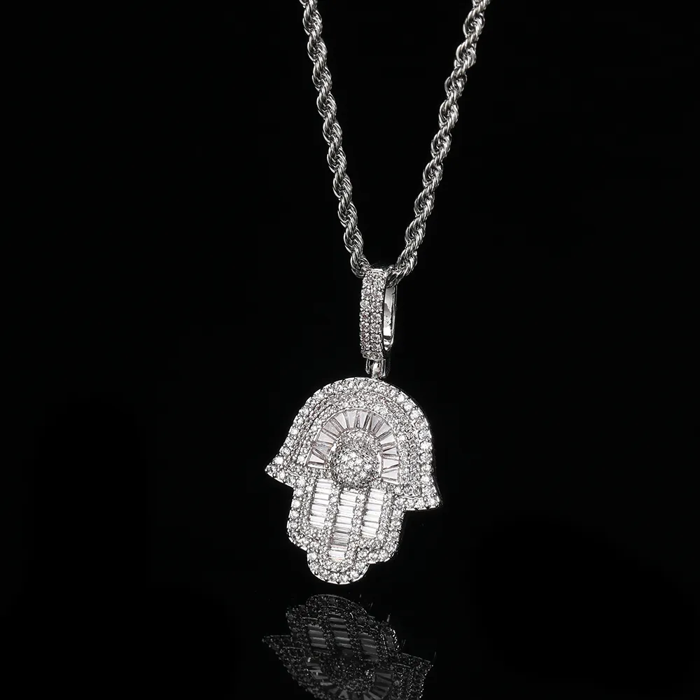 The White Gold Hamsah Hand Pendant offers a sleek and modern take on this ancient symbol of protection and fortune. Adorned with VVS simulated diamonds, the pendant sparkles with a polished, reflective surface. Its White Gold plating brings a touch of elegance, making it a versatile accessory for both casual and formal settings. Hypoallergenic, waterproof, and scratch-resistant, this pendant is designed for durability and long-lasting wear. Whether you're looking for a meaningful gift or adding spiritual flair to your Hip-Hop wardrobe, the White Gold Hamsah Hand Pendant is the perfect choice.