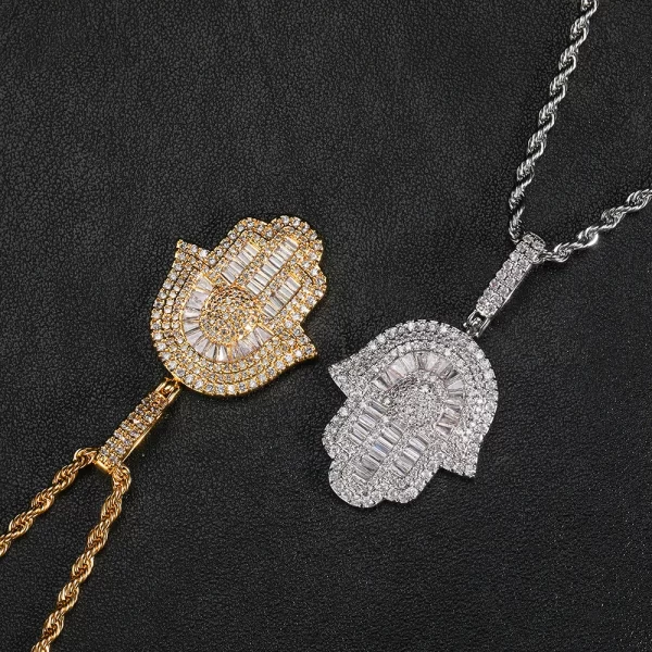 The Hamsah Hand Pendant in Yellow Gold is a 28mm symbol of protection and good fortune, elegantly designed with VVS simulated diamonds. The Yellow Gold plating gives it a luxurious and eye-catching shine, perfect for adding a touch of bling to your casual or formal outfits. Hypoallergenic, waterproof, and scratch-resistant, this pendant is built to last while maintaining its bold and polished look. Whether worn solo or layered with other pieces, the Hamsah Hand Pendant brings both style and spiritual significance, making it a must-have for those who appreciate Hip-Hop culture with a touch of tradition.