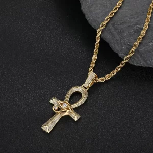 The Eye of Ra Ankh Cross Pendant in Yellow Gold brings together two powerful symbols of ancient Egyptian mythology with a modern Hip-Hop twist. Adorned with VVS simulated diamonds, this intricate pendant sparkles with a radiant shine. The Yellow Gold plating gives it a bold and luxurious appearance, while its waterproof, hypoallergenic, and scratch-resistant qualities ensure long-lasting durability. Perfect for expressing your personal style, this pendant makes a statement both in casual settings and formal occasions, blending faith, culture, and luxury effortlessly.