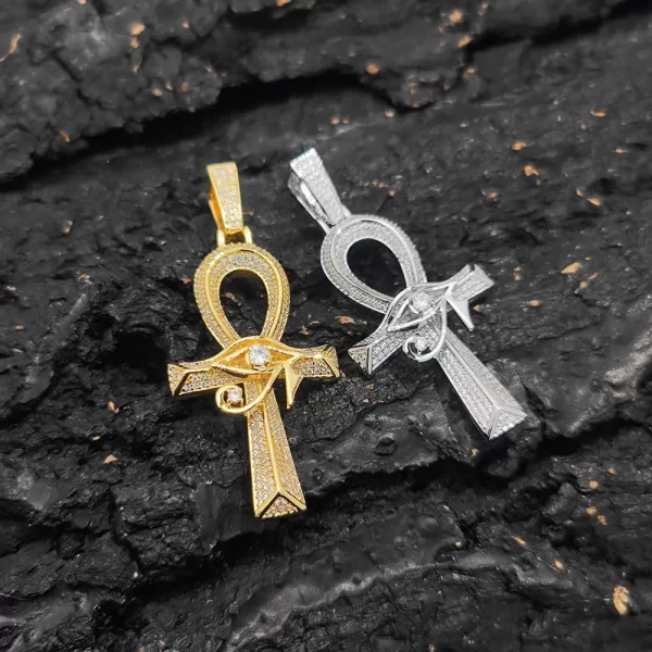 The Eye of Ra Ankh Cross Pendant in Yellow Gold brings together two powerful symbols of ancient Egyptian mythology with a modern Hip-Hop twist. Adorned with VVS simulated diamonds, this intricate pendant sparkles with a radiant shine. The Yellow Gold plating gives it a bold and luxurious appearance, while its waterproof, hypoallergenic, and scratch-resistant qualities ensure long-lasting durability. Perfect for expressing your personal style, this pendant makes a statement both in casual settings and formal occasions, blending faith, culture, and luxury effortlessly.