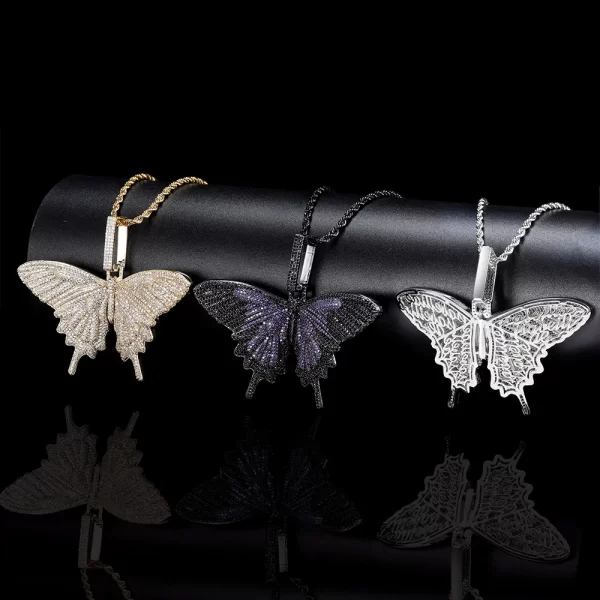 The Iced Butterfly Pendant in Dark Purple offers a striking and luxurious touch to your jewelry collection. The Dark Purple plating is paired with sparkling stones that shimmer in any light, creating a captivating contrast. This pendant is hypoallergenic, waterproof, and scratch-resistant, making it suitable for everyday wear. Its unique color and design make it ideal for those who appreciate bold, eye-catching accessories with a playful Hip Hop vibe.