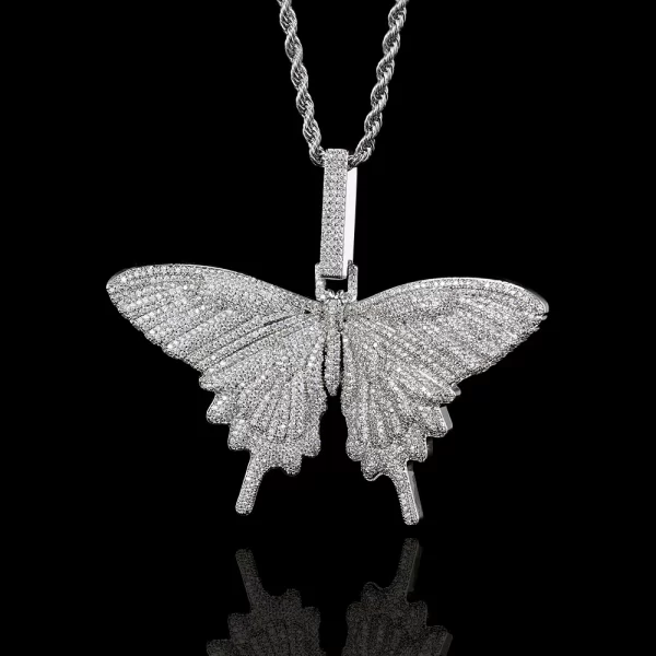 The Iced Butterfly Pendant in White Gold brings a touch of modern sophistication to a playful design. Set with shimmering stones, it offers the delicate allure of a butterfly while the White Gold-plated finish adds a polished, luxurious shine. Hypoallergenic, waterproof, and scratch-resistant, it’s built to last through everyday wear. Ideal for those who love elegant yet fun accessories, this pendant is a versatile piece for any jewelry collection, embodying both luxury and Hip Hop aesthetics.